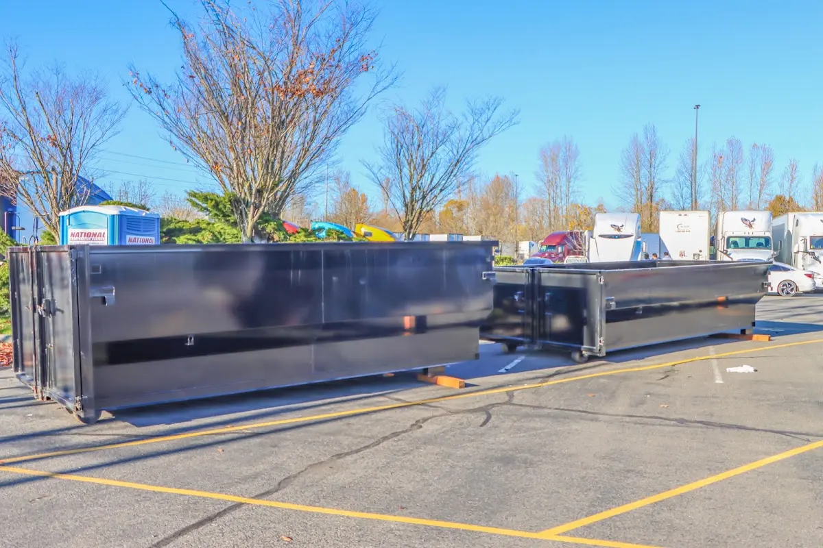 Professional dumpster rental service with roll-off container on residential driveway in Kingsburg